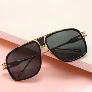 Detail of vintage round metal aviator sunglasses with black and gold double bridge frame
