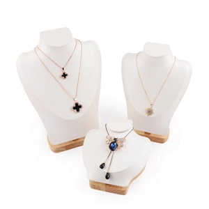 Rose gold necklace set with clover and bee pendants on elegant neck mannequin displays