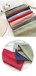 Close-up of ribbed knit headbands in various colors showing soft fabric textures