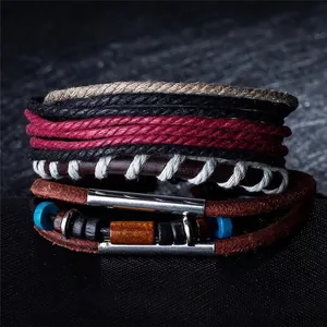 Close-up of bohemian multilayer leather bracelets with wood beads and woven hemp cords