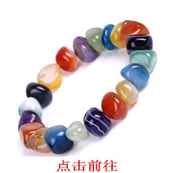 Close-up of polished multi-color natural gemstone chips bracelet on a white background