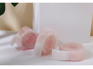 Three packs of invisible lace double eyelid tape in heart-shaped pink cases on a clean desk
