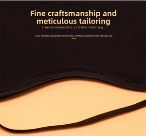 Detail of black breathable sleep mask with fine tailoring and elastic strap on orange background
