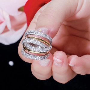 Elegant multi-layer intertwined ring with gold and silver finish featuring full pavé crystals