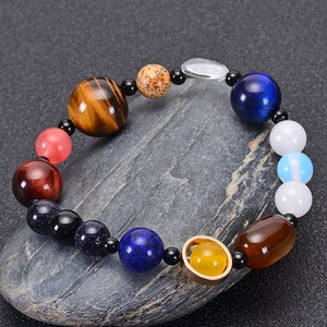 Solar system bracelet with natural blue sandstone and planet stones on grey stone