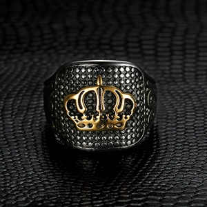 Macro shot of vintage crown signet ring with black finish and gold crown detail