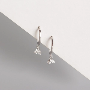 Detail of silver S925 hoop earrings featuring three sparkling clear crystal pendants