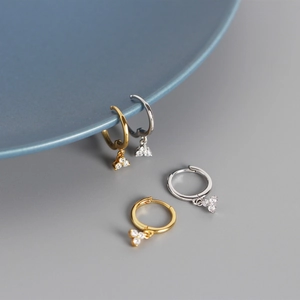 Detail view of S925 sterling silver hoop earrings with three cubic zirconia charms