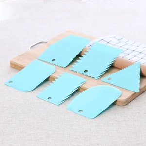 6-piece light blue plastic cake scraper set with various shapes on a wooden board