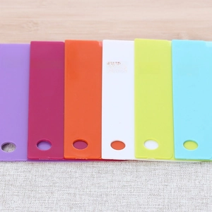 Close-up of 6 colorful plastic cake scrapers with hanging holes for kitchen baking