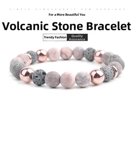 Macro shot of lava rock beads and pink marble stones on an elastic yoga bracelet