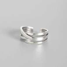 Macro detail of S925 sterling silver Mobius twist ring with layered cross design