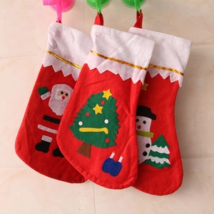 Detailed view of three hanging Christmas stockings featuring Santa, snowman and tree designs