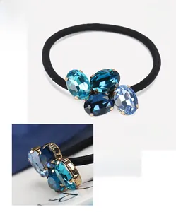 Detailed close-up of crystal hair tie showing blue oval rhinestones and net weight 6.8g