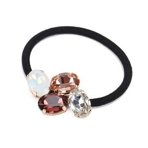 Close-up of multicolor oval crystal rhinestones on a high-elastic black hair tie
