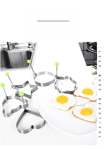 Kitchen scene with heart and flower stainless steel fried egg molds with green handles