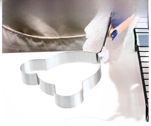 Macro shot of bear-shaped stainless steel egg mold with handle for creative cooking