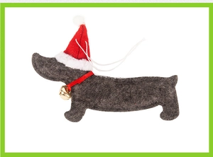 Close-up of a black dachshund felt ornament wearing a red Santa hat and golden bell