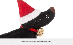 Detailed macro of handmade felt dachshund Christmas ornament with red hat and bell