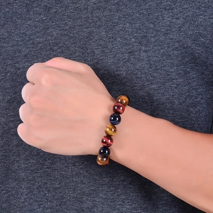 Natural tiger eye stone bracelet with yellow and red beads on a stretch cord