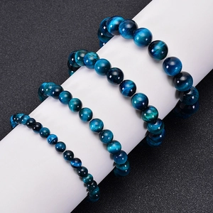 Three natural blue tiger eye stone beaded bracelets in various sizes on white display