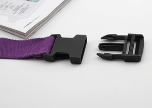 Detail of purple nylon canvas belt featuring a black plastic buckle and durable texture