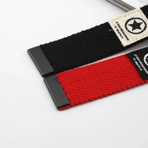 Detail of red and black kids woven fabric belts with plastic buckles and ZT Kids tags