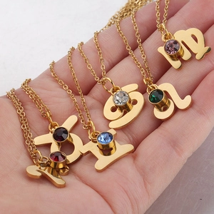 Gold zodiac necklaces set with colorful crystal birthstones on polished stainless chains