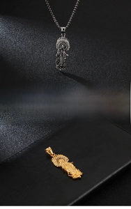 Macro detail of Virgin Mary pendant in gold and silver finish with crystal inlay
