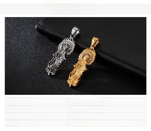Macro detail of gold and silver Virgin Mary pendants with rhinestones on black leather