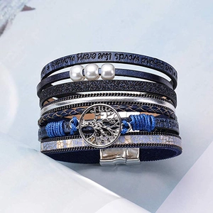 Close-up of bohemian blue multilayer leather bracelet with tree of life charm and pearls