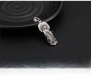 Detail of vintage silver Virgin Mary pendant necklace with sparkling crystal halo