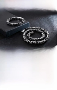 Detail of vintage Byzantine weave chain necklace and bracelet set in blackened titanium steel