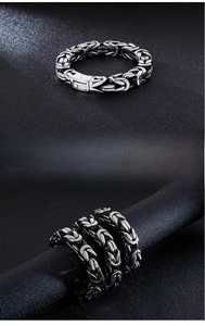 Detail of silver men's Byzantine weave steel bracelet with secure square push buckle