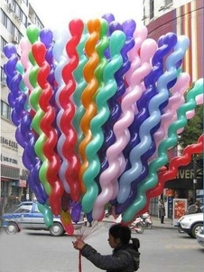 Close-up of colorful spiral latex balloons in red blue green and purple for party decor