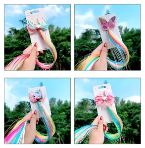 Detail view of colorful unicorn hair clips with rainbow extensions for little girls