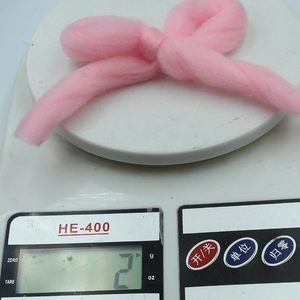 Pink macaron flocked Christmas bow hanging ornament weighing approximately 2 grams
