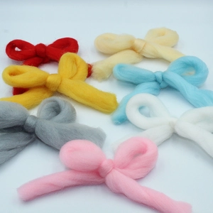 Macro detail of seven colorful handmade flocking ribbon bows for Christmas DIY crafts