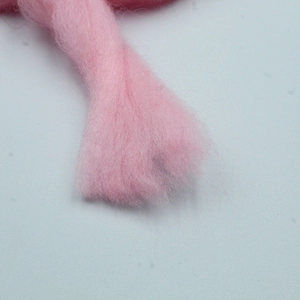 Macro shot of soft pink macaron flocked Christmas tree bow ornament with fluffy texture