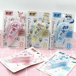 Flat lay of colorful cartoon correction tapes in pink yellow and blue on grid background
