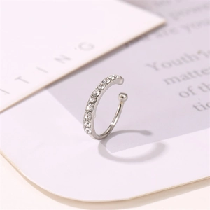 Elegant silver ear cuff with sparkling white rhinestones in a minimalist C-shaped design