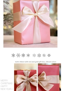 Close-up of pink and red Christmas gift boxes with pearl finish and satin bow ribbons