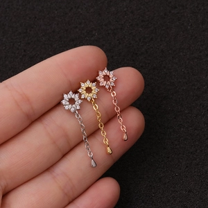 Three flower-shaped stainless steel drop earrings in silver, gold, and rose gold finishes