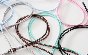 Detail of colorful elastic lanyards with polka dot patterns and metal clasps