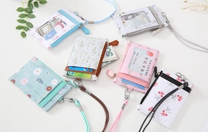 Flat lay of PU leather card holders with floral patterns, lanyards and zipper coin pouch