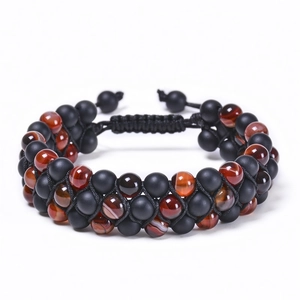 Detailed shot of double-layered braided bracelet with matte black and red onyx beads