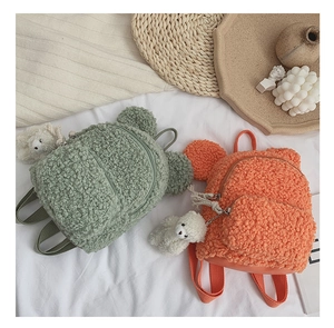 Détail de la texture peluche du sac à dos en polaire avec oreilles d'ours et charm