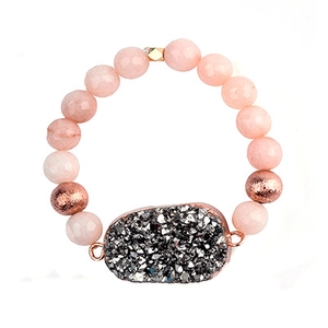 Detail shot of pink quartz beaded bracelet with rose gold beads and druzy stone charm