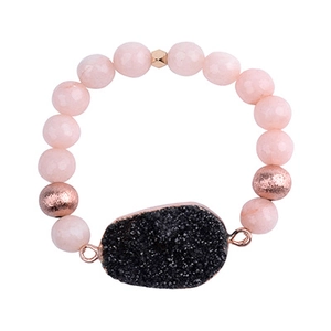 Detail of beaded quartz bracelet with rose gold accents and druzy stone pendant