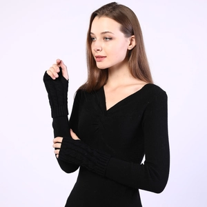 Detailed close-up of black cable knit fingerless arm warmers with vertical ribbed texture
